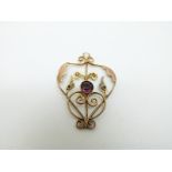 A 9ct gold Edwardian/ Art Nouveau pendant set with an amethyst