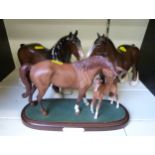 Two Beswick standing Shire horses and a Royal Doulton 'First Born' figure