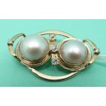 A 9ct gold brooch set with two Mabé pearls and five old cut diamonds