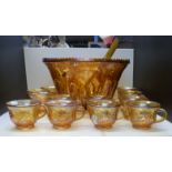 A carnival glass pedestal punch bowl set with cups, ladle and hangers,