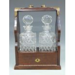 A two bottle tantalus with Edinburgh Crystal decanters,
