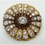 A mid-Victorian brooch in the form of a stylised flower set with an old mine cut diamond measuring
