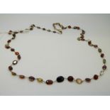 A 14ct gold necklace set with multicoloured garnets and quartz