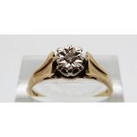 An 18ct gold ring set with a diamond in an illusion setting, size R,