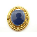 A large Victorian swivel brooch with twisted rope border and engraved foliate design