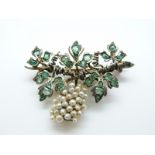 A silver gilt brooch set with emeralds and pearls in the form of a grape vine