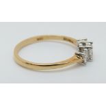 An 18ct gold ring set with three princess cut diamonds totalling approximately 0.