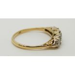 An 18ct gold ring set with five graduated diamonds, the centre stone approximately 0.