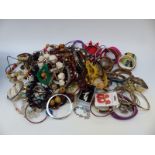 A collection of costume jewellery to include a pair of silver earrings, beads,