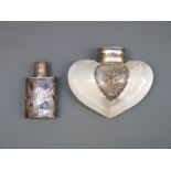 A mother of pearl scent bottle with white metal mounts and a white metal scent bottle with piecrced
