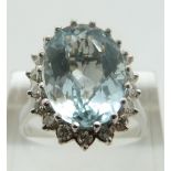 An 18ct white gold ring set with a central oval mixed cut aquamarine of approximately 2ct in a