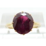 A yellow metal ring set with a synthetic ruby, size L, 2.