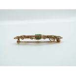 A 9ct gold brooch set with an oval cut emerald measuring approximately 0.75ct, 4.