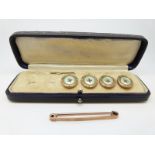 A 9ct rose gold brooch and four buttons set with mother-of-pearl