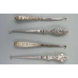 Four various hallmarked silver handled button hooks