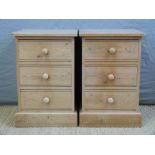 A pair of pine three drawer bedside cabinets,