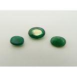 Five apple green oval cut emeralds, the largest approximately 0.