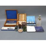 A cased set of hallmarked silver handled knives, plated lockable decanter,