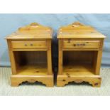 A pair of pine bedside cabinets,