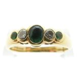 An 18ct gold ring set with three emeralds and diamonds, size T/U, 5.