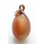 A sunstone egg pendant with a yellow metal fitting,