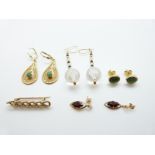 A pair of 14k gold earrings set with an emerald cabochon to each (4.