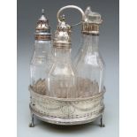 A George III hallmarked silver five bottle cruet with pierced decoration mahogany base raised on