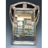 A Spanish white metal or similar Art Nouveau bevelled glass mirror impressed marks including Menese