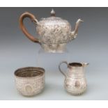 A Victorian Goldsmiths & Silversmiths Company hallmarked silver three piece bachelor's teaset with