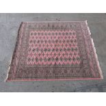 A Pakistan made 100% wool pink ground Afghan rug,