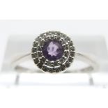 A 9ct white gold ring set with an amethyst and diamonds, size O, 2.