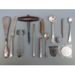 A collection of items to include corkscrew, white metal spoons,
