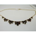 A 10ct gold necklace set with Bohemian cut garnets in seven graduated garnitures