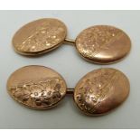 A pair of 9ct gold cufflinks with floral decoration,