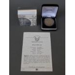 A 1925 Liberty peace dollar of the USA in a Coins of America case,