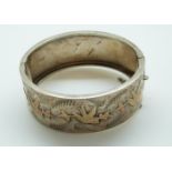 A large Victorian silver bangle with applied gold swallow design