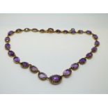 A Victorian necklace set with graduated oval cut amethysts, the largest approximately 8.