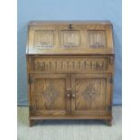 A linenfold carved oak bureau,