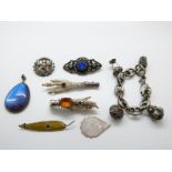 A white metal Eastern bracelet set with cabochons, a silver pendant set with butterfly wing,