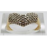 An 18ct gold ring set with diamonds in a V shape, size P, 3.