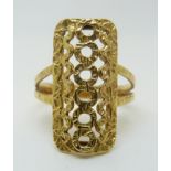 A yellow metal ring with a pierced rectangular design, 5.