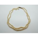 A two strand cultured pearl necklace with 9ct gold clasp set with an amethyst and pearls