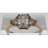 A 9ct gold ring set with an emerald cut cubic zirconia and two triangular cubic zirconia, size N, 2.