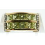 A 9ct gold ring set with square peridot and diamonds, size K, 3.