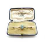 A 15ct gold brooch set with a zircon with a platinum finish