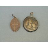 Ancient bronze oval coin, possibly Greek, depicting two perched eagles, the coin attached to a loop,