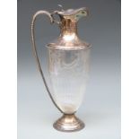 An Edward VII hallmarked silver and glass claret jug with cut glass decoration,
