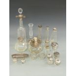 A large collection of hallmarked silver mounted glass items comprising cut glass decanter,