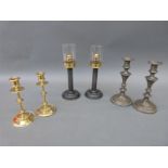 Three pairs of candlesticks comprising one brass,