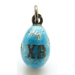 A Russian silver egg pendant set with aqua enamel, 'XB' to one side and a seed pearl to the other,